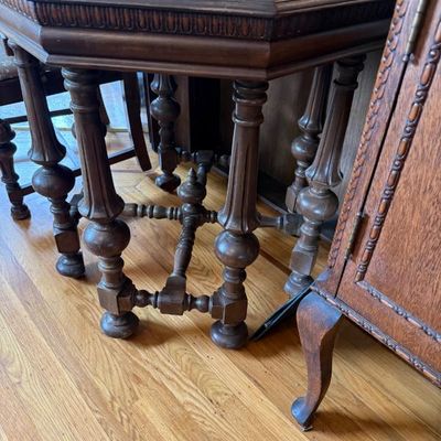Sale Photo Thumbnail #318: Vintage dark wood octagonal accent table featuring ornate turned legs, carved apron details, and a central stretcher base.