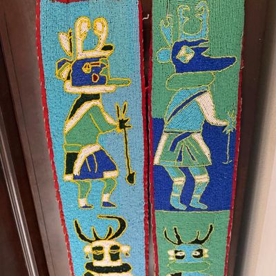 Sale Photo Thumbnail #235: Pair of vintage Native American style beaded fabric wall hangings depicting Kachina figures on a wooden dowel.