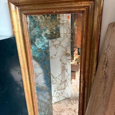 Sale Photo Thumbnail #270: Vintage rectangular wall mirror with a gilded wooden frame and heavily foxed, antiqued glass.