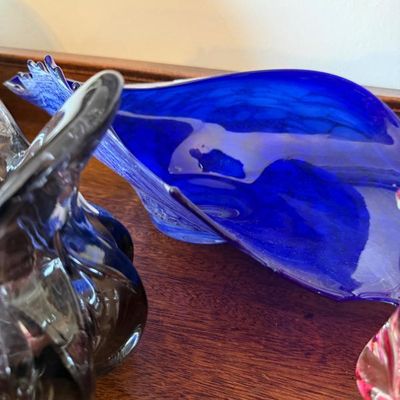 Sale Photo Thumbnail #21: Mid-century modern cobalt blue art glass dish featuring a freeform leaf-like shape alongside other decorative art glass pieces.
