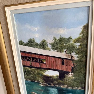 Sale Photo Thumbnail #88: Framed oil painting depicting a red covered bridge over a river, signed by artist H. De Ceyne in the lower right corner.