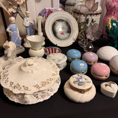 Sale Photo Thumbnail #164: Collection of vintage porcelain figurines, trinket boxes, and decorative glassware, including pastels, a kitten portrait plate, and a gold-trimmed covered dish.