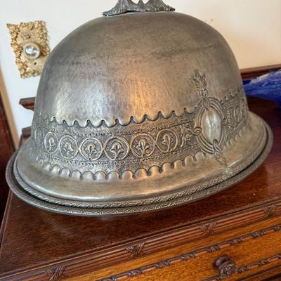 Sale Photo Thumbnail #15: Antique silver-plated meat dome cloche with intricate repoussé banding, an ornate top handle, and matching underplate.