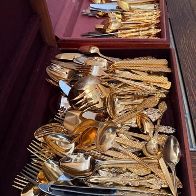 Sale Photo Thumbnail #10: Large collection of gold-electroplated flatware organized inside felt-lined wooden silverware storage chests.