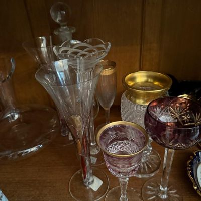 Sale Photo Thumbnail #345: Collection of vintage crystal glassware, featuring etched and cut design stems with gold accents and a dark purple overlay glass coupe.