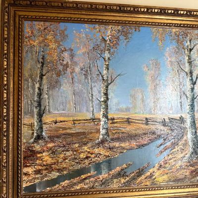 Sale Photo Thumbnail #58: Large oil painting depicting a rustic autumn landscape with birch trees and a small stream, set in an ornate gilded wood frame.