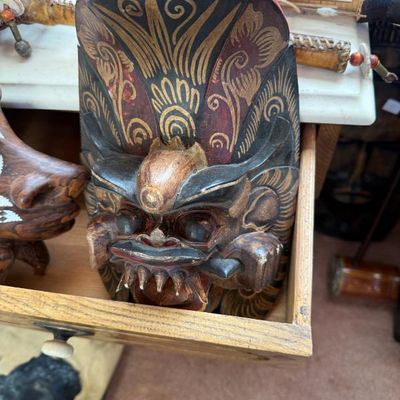 Sale Photo Thumbnail #219: Hand-carved Balinese Barong demon mask featuring painted gold scrollwork accents, red highlights, and protruding fangs.