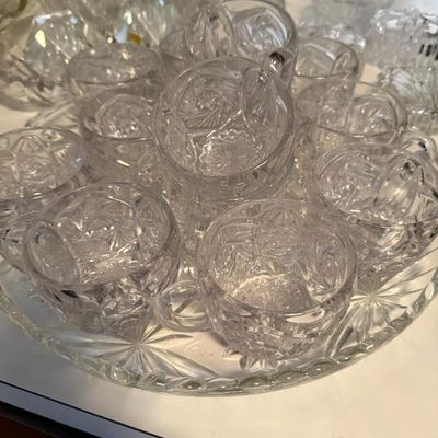 Sale Photo Thumbnail #303: Vintage cut glass punch bowl set with multiple matching cups on a round starburst tray.