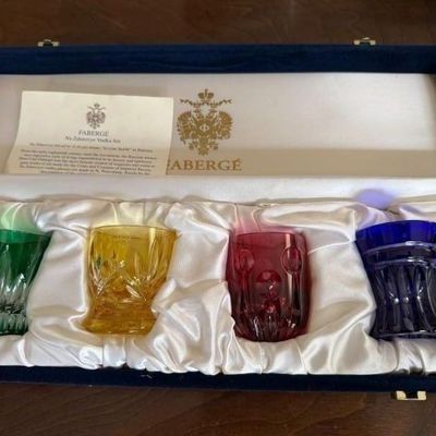 Sale Photo Thumbnail #4: Fabergé Na Zdorovye crystal vodka set featuring four colorful cut-glass glasses in a satin-lined presentation box with paperwork.