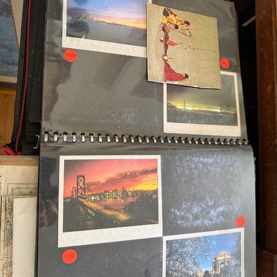 Sale Photo Thumbnail #176: Open binder containing various San Francisco postcards and art prints stored in clear protective sleeves.