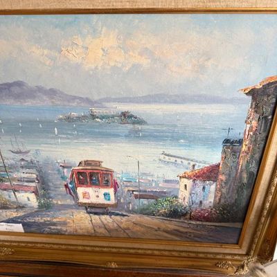 Sale Photo Thumbnail #90: Framed oil painting depicting a San Francisco cable car descending a hill toward the bay with Alcatraz Island in the distance, housed in an ornate gilt wood frame.