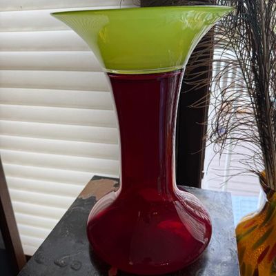 Sale Photo Thumbnail #17: Mid-century modern style two-tone art glass vase featuring a deep red body and a flared lime green rim.