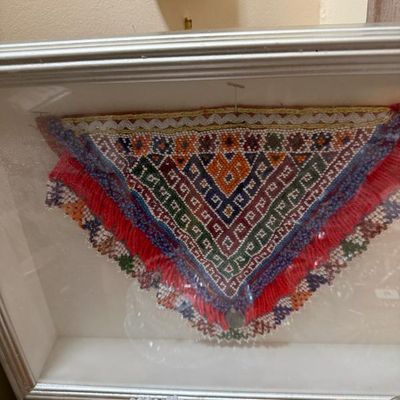 Sale Photo Thumbnail #157: Framed shadow box displaying a detailed, colorful beaded ethnic textile trim with red fringe.