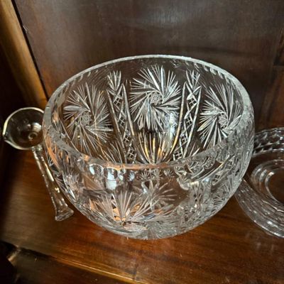 Sale Photo Thumbnail #292: American Brilliant Period cut crystal punch bowl featuring intricate pinwheel and star motifs, displayed with a matching glass ladle.