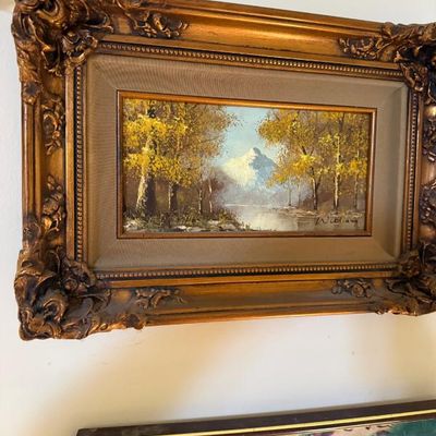 Sale Photo Thumbnail #66: Framed vintage oil painting depicting a fall mountain landscape with a snow-capped peak, presented in an ornate gold-finished frame with a beige mat.