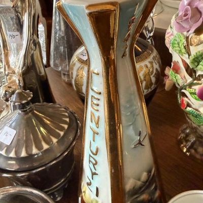 Sale Photo Thumbnail #326: Vintage 1962 Seattle World's Fair 'Century 21' commemorative ceramic decanter with gold trim, displayed alongside other glassware and silver items.