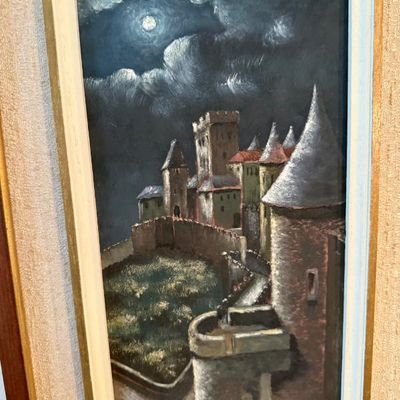 Sale Photo Thumbnail #99: Framed oil painting depicting a medieval castle under a moonlit, cloudy night sky, signed in the bottom right corner.