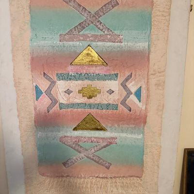 Sale Photo Thumbnail #122: Framed Southwestern-style cast paper relief art featuring geometric patterns in pastel colors and metallic gold accents.