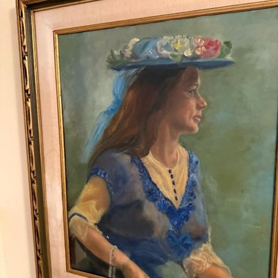 Sale Photo Thumbnail #54: Framed oil portrait painting depicting a profile view of a woman in a blue floral hat and blue lace dress, housed in an ornate carved wooden frame with a fabric mat liner.