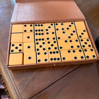 Sale Photo Thumbnail #287: Vintage double-six domino set in butterscotch Bakelite or plastic, complete in its original brown textured storage box.