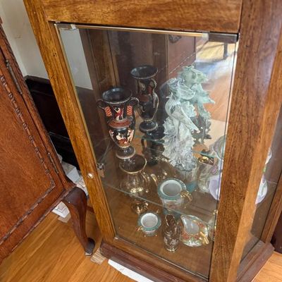 Sale Photo Thumbnail #323: Wooden display curio cabinet featuring glass shelves filled with collectible miniature urns, vases, and ceramic figurines.