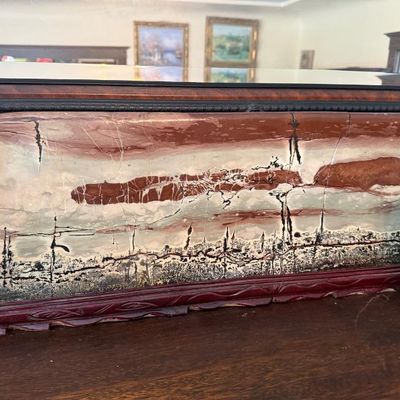 Sale Photo Thumbnail #352: Large polished picture jasper slab displaying natural scenic landscape patterns, mounted on a carved dark wooden display stand.