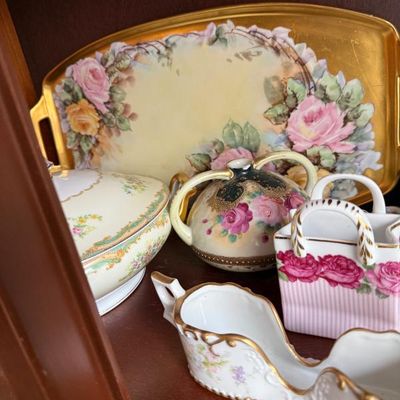 Sale Photo Thumbnail #334: Collection of antique and vintage porcelain tableware, including a hand-painted floral serving tray with gilded trim, a matching vase, a covered dish, and small trinket holders.