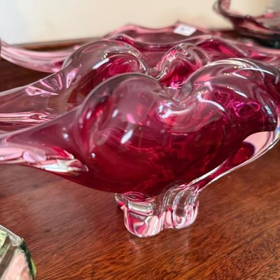 Sale Photo Thumbnail #19: Collection of mid-century Murano-style cranberry glass bowls featuring freeform organic shapes and clear glass pedestal bases.