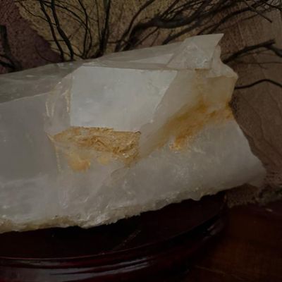Sale Photo Thumbnail #132: Large quartz crystal specimen mounted on a dark wooden carved display base.
