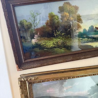 Sale Photo Thumbnail #73: Two framed vintage landscape prints mounted on a wall, featuring ornate dark wood and gilded gold frames.