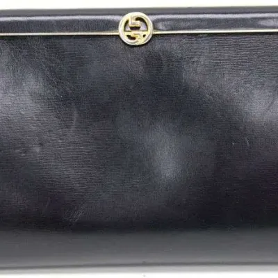 Vintage Gucci black leather clutch handbag featuring a gold-tone interlocking GG logo hardware closure.