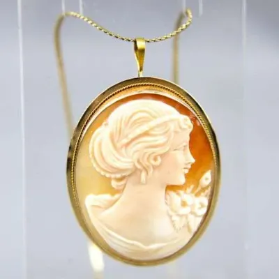 Vintage carved shell cameo pendant featuring a classical woman's profile, set in a gold-tone twisted wire bezel with an included...