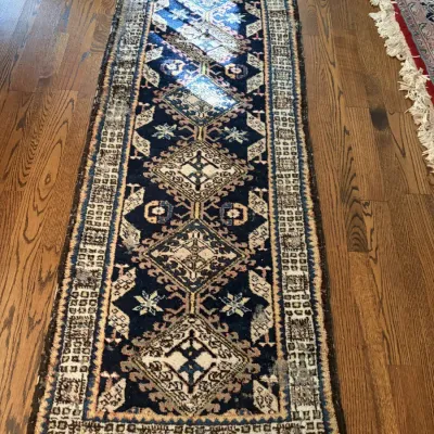 Sale Photo Thumbnail #2: Hand-knotted Persian wool runner rug featuring a navy blue field with geometric diamond medallions, intricate borders, and fringed ends.