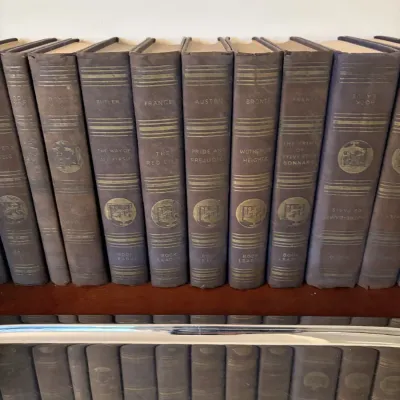 Sale Photo Thumbnail #19: Collection of vintage blue cloth-bound classic books, including titles from the Book League series, lined up on a shelf.