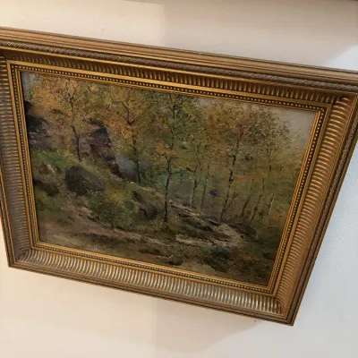 Sale Photo Thumbnail #35: Framed impressionist oil painting depicting a rocky woodland landscape, set in a heavily detailed gilt wood frame.