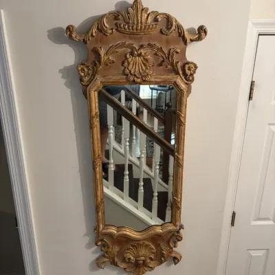 Sale Photo Thumbnail #97: Vintage Baroque-style ornate wall mirror with a giltwood finish, carved shell motifs, and floral flourishes.