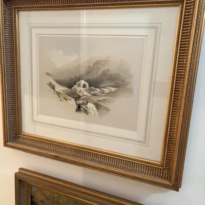Sale Photo Thumbnail #34: Framed Orientalist landscape print depicting a Middle Eastern or North African village, housed in an ornate giltwood frame with a wide white mat.