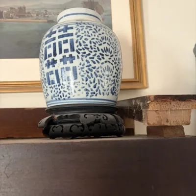 Sale Photo Thumbnail #66: Chinese blue and white porcelain ginger jar featuring a double happiness symbol, displayed on a carved dark wood stand.