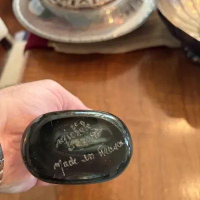Sale Photo Thumbnail #118: Handheld dark glass object showing an etched maker's mark and 'Made in France' signature on the bottom.