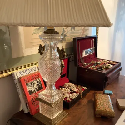 Sale Photo Thumbnail #122: Traditional cut-glass table lamp with brass accents and pleated shade, displayed alongside a jewelry box with contents and decorative trinkets.