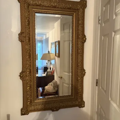 Sale Photo Thumbnail #87: Large ornate giltwood wall mirror with detailed relief molding and textured borders, Victorian or Rococo Revival style.