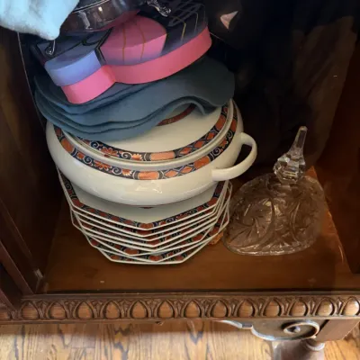 Sale Photo Thumbnail #27: Stack of patterned porcelain china including a covered tureen and salad plates, alongside a vintage cut glass dish in a wooden cabinet.