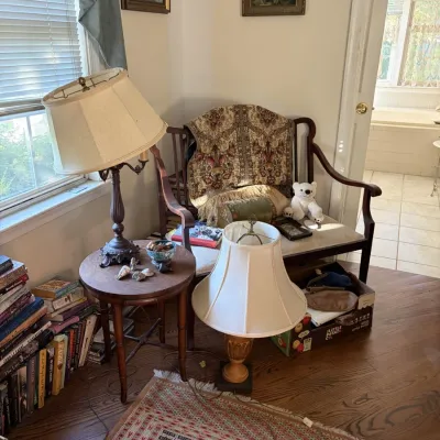 Sale Photo Thumbnail #61: Vintage wooden bench set in a cozy corner alongside table lamps, a small accent table, books, framed wall art, and an oriental area rug.