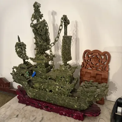 Sale Photo Thumbnail #45: Intricately carved green jade or hardstone Chinese dragon boat sculpture, mounted on a custom carved wood display stand.