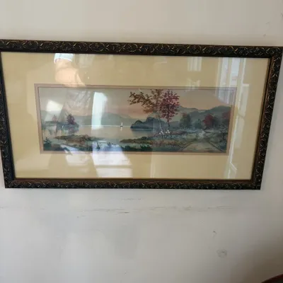 Sale Photo Thumbnail #116: Framed panoramic watercolor landscape print featuring a lake scene with autumn trees and a sailboat, housed in an ornate dark wood frame.