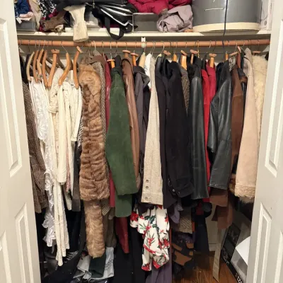 Sale Photo Thumbnail #131: Closet filled with women's coats and jackets, including leather, faux fur, and wool outerwear, with hats and bags stored on the top shelf.