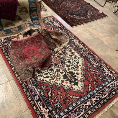 Sale Photo Thumbnail #111: Collection of hand-woven oriental area rugs and runners in various red, cream, and blue geometric patterns.