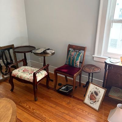 Sale Photo Thumbnail #18: Collection of vintage accent furniture, including a floral upholstered vanity bench, a wooden side chair with a burgundy velvet seat, and several small pedestal tables.