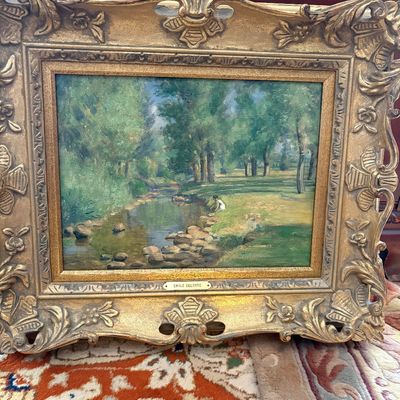 Sale Photo Thumbnail #21: Framed impressionist oil painting on canvas depicting a serene stream landscape, attributed to Emile Delobre, housed in an ornate gilded baroque-style frame.