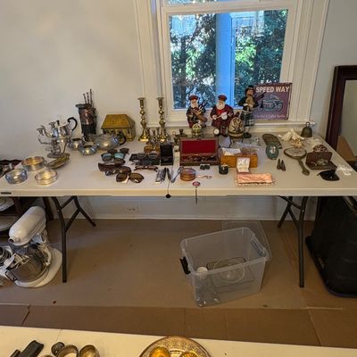 Sale Photo Thumbnail #43: Folding display table holding various small collectibles, including silver-plated teapots, brass candlesticks, sunglasses, jewelry boxes, and decorative figurines.